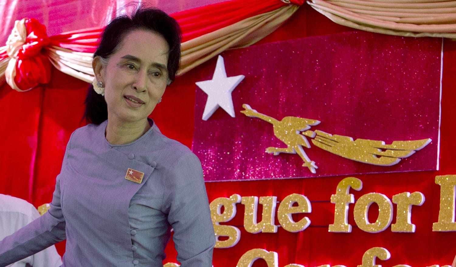 Opposition leader Aung San Suu Kyi leaves a press conference Thursday at her home in Yangon, Myanmar.