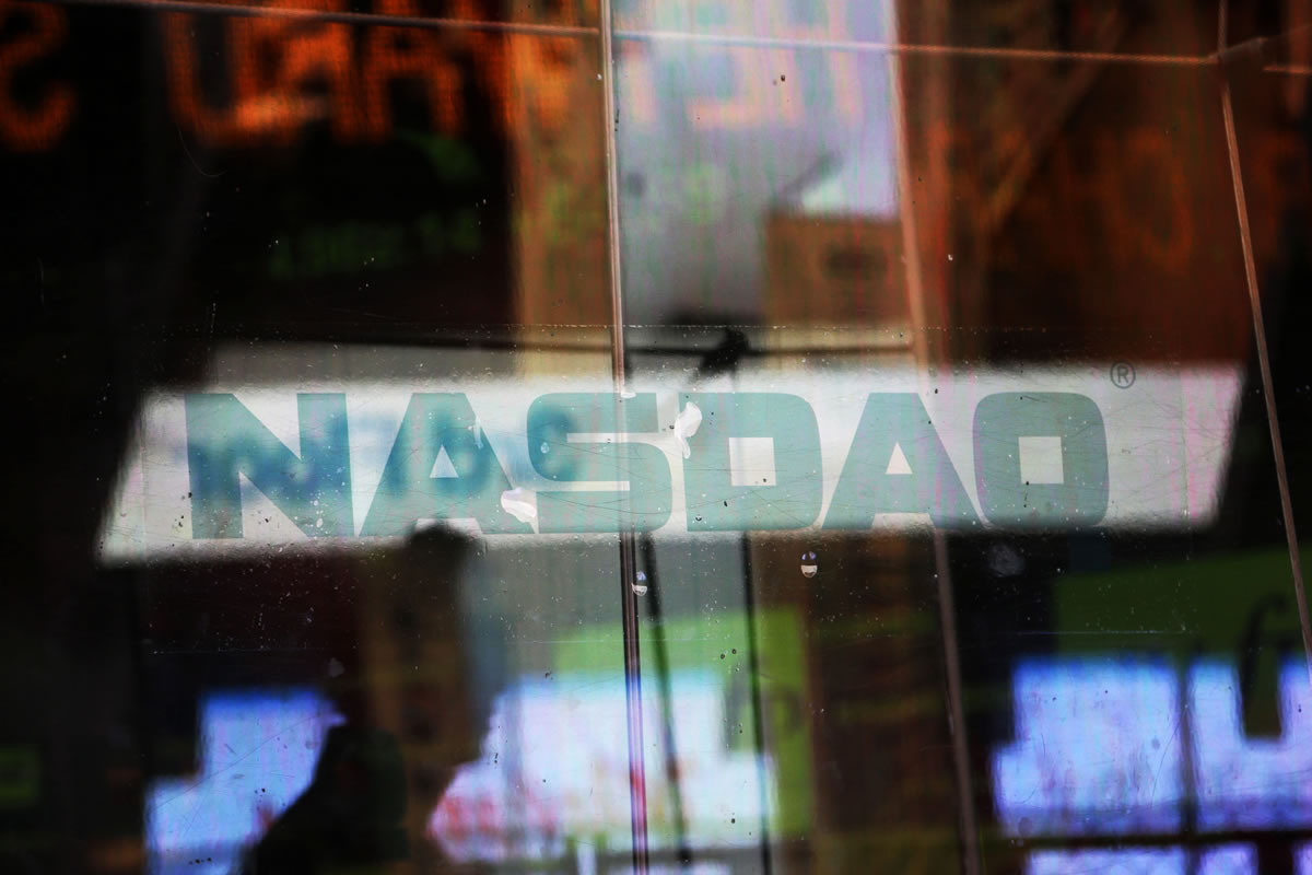 Electronic billboards are reflected in the windows of Nasdaq in New York.