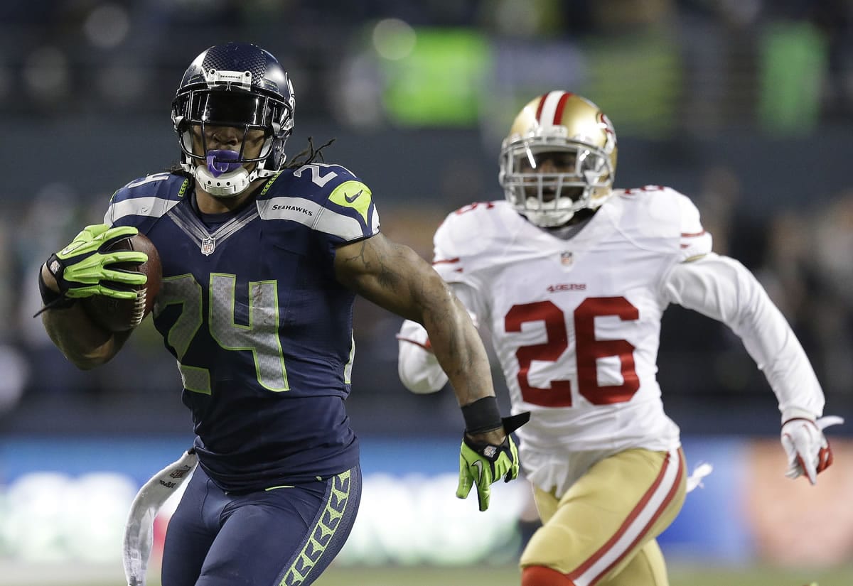 Seattle Seahawks' Marshawn Lynch (24) breaks away from San Francisco 49ers' Tramaine Brock (26) for a 40-yard touchdown run during the third quarter Sunday.