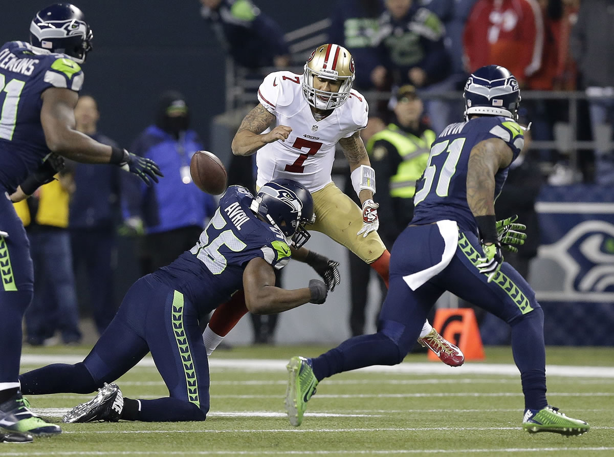 Seattle's Cliff Avril sacks San Francisco's Colin Kaepernick (7), forcing a fumble recovered by the Seahawks.