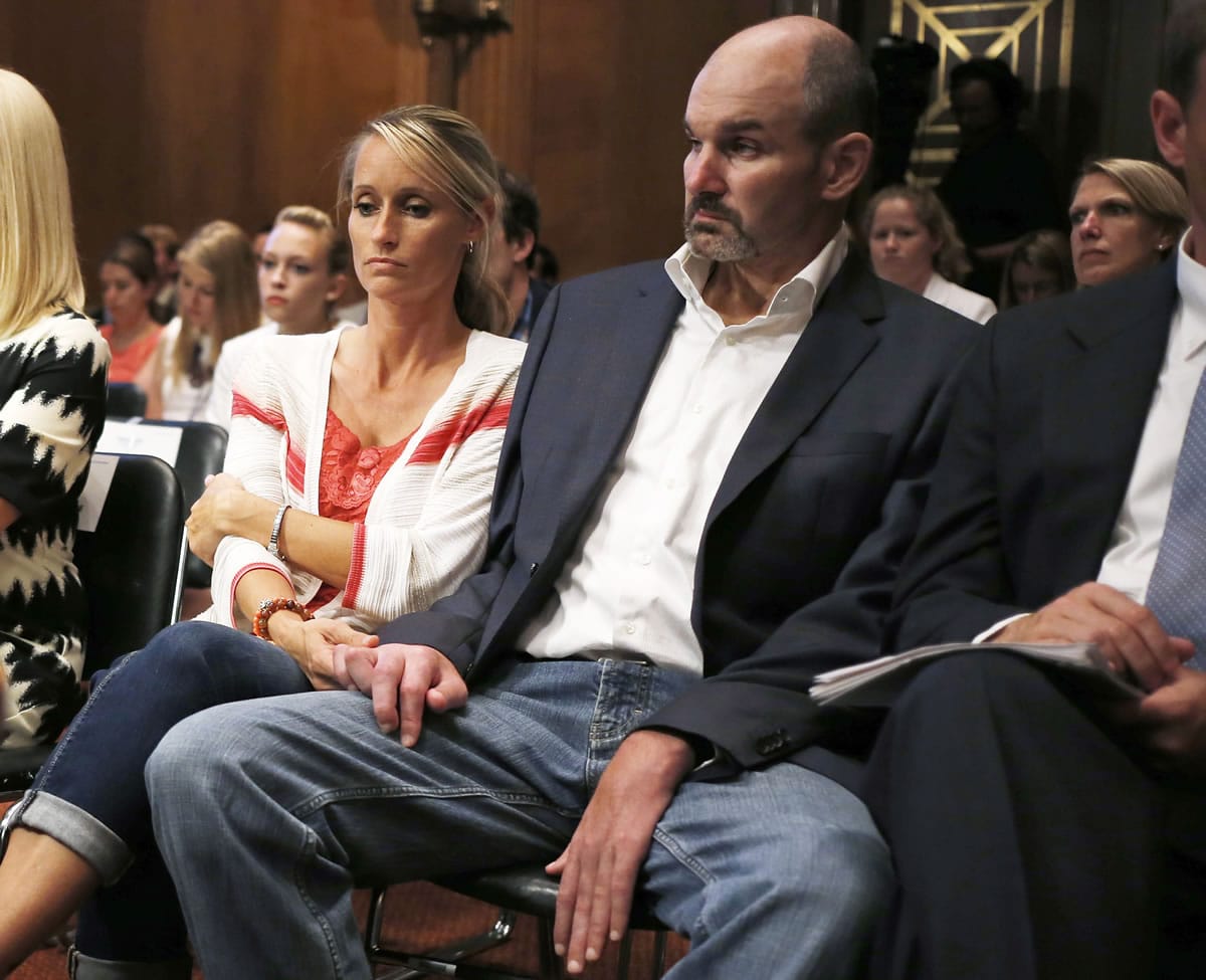 Former NFL football player Kevin Turner, right, who suffers from Lou Gehrig&#039;s disease, listens during testimony before the Senate Special Committee on Aging hearing regarding concussions and the long term effects of brain related sports injuries in Washington. The NFL will ask a U.S. appeals court to uphold a potential $1 billion plan to settle thousands of concussion lawsuits filed by former players on Thursday, Nov. 19, 2015.