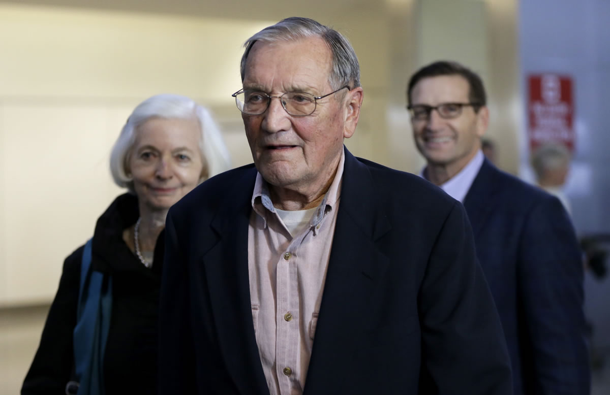 Merrill Newman, center, walks beside his wife, Lee, left, and his son, Jeffrey, after arriving at San Francisco International Airport on Saturday. Newman was detained in North Korea late October at the end of a 10-day trip to North Korea, a visit that came six decades after he oversaw a group of South Korean wartime guerrillas during the 1950-53 war.