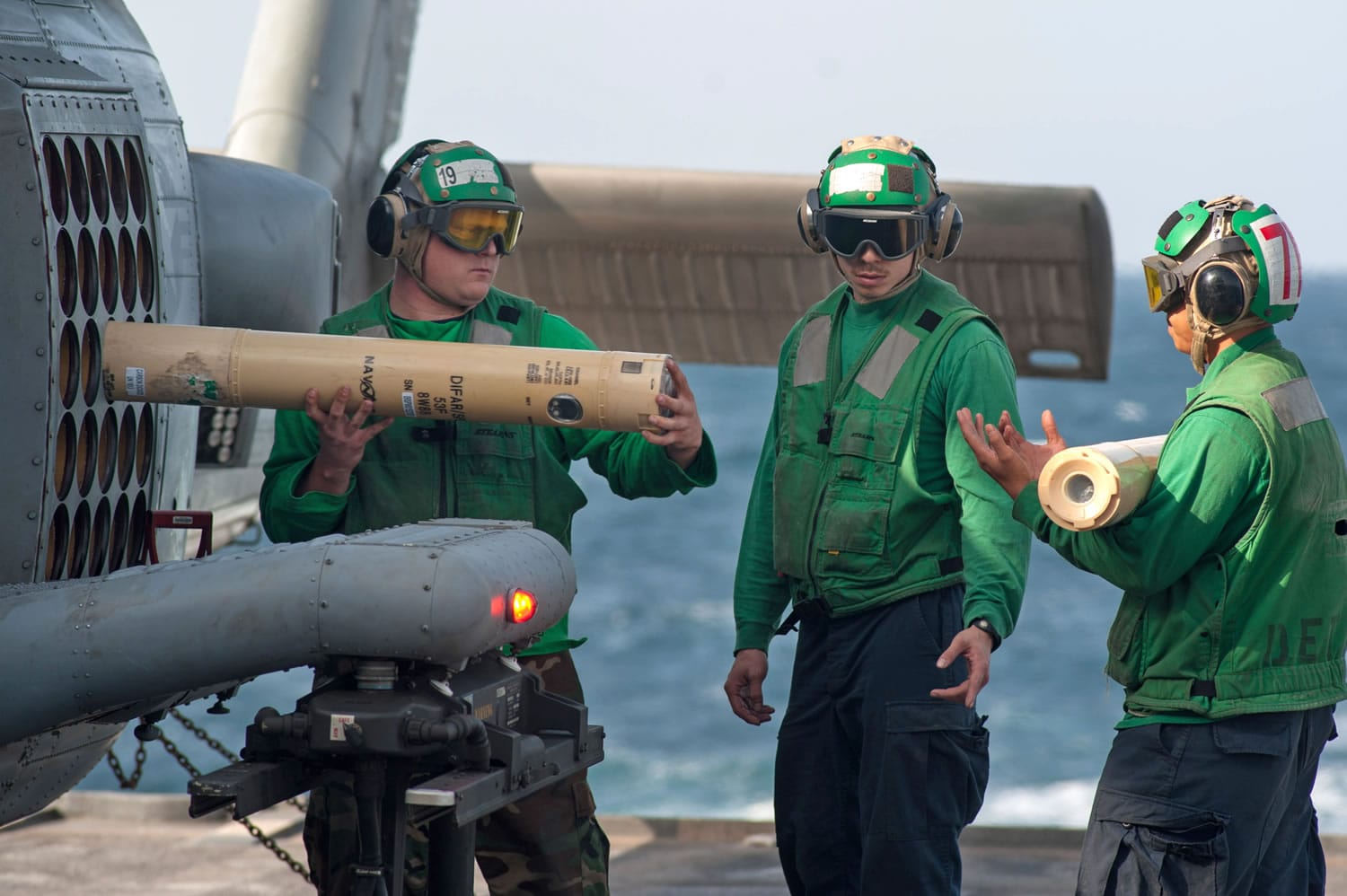 Sailors unload sonobuoys from an MH-60R Sea Hawk helicopter aboard the guided-missile cruiser USS Mobile Bay in the Arabian Sea. NOAA is issuing permits to the Navy, which wants to expand sonar and other training exercises off the West Coast. (U.S.