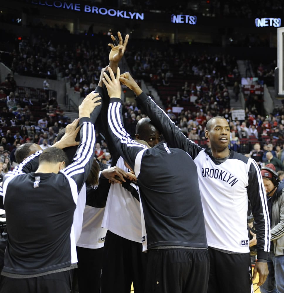 Brooklyn's Jason Collins, right, cheers with teammates before Wednesday's game against the Portland Trail Blazers at the Moda Center.