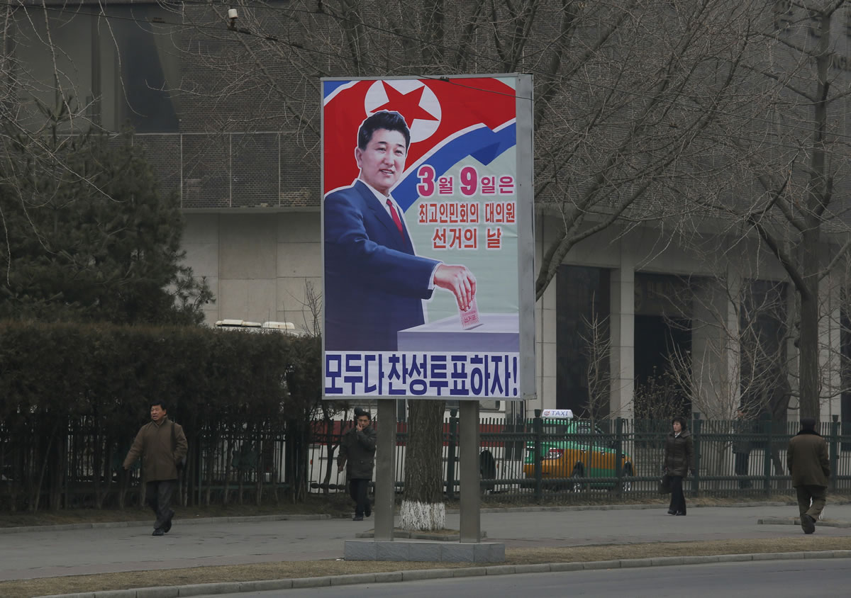 In this Monday Feb. 24, 2014 photo, North Koreans walk past an election poster that reads: &quot;March 9 is the election of the 13th Supreme Peopleis Assembly, Letis all vote in agreement!&quot; in Pyongyang, North Korea. North Korean voters will make a choice Sunday, March 9 when they elect a new national legislature, but not for a candidate. The ruling elite have already done that for them, and thereis only one per district.