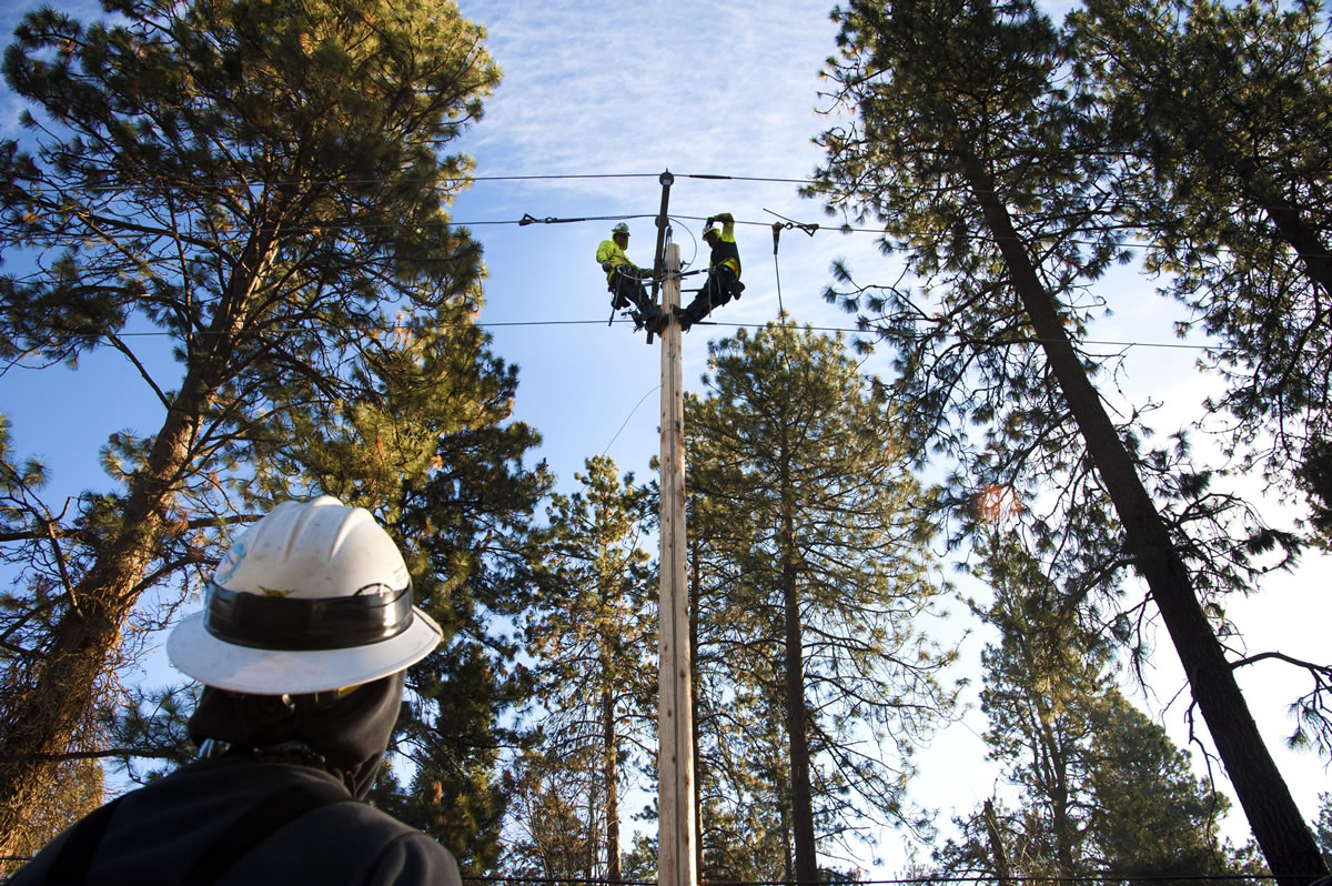 Line crews from Sturgeon Electric based in Oregon repair a stretch of power lines in Spokane that were damaged by a windstorm that hit the area  Nov. 17.