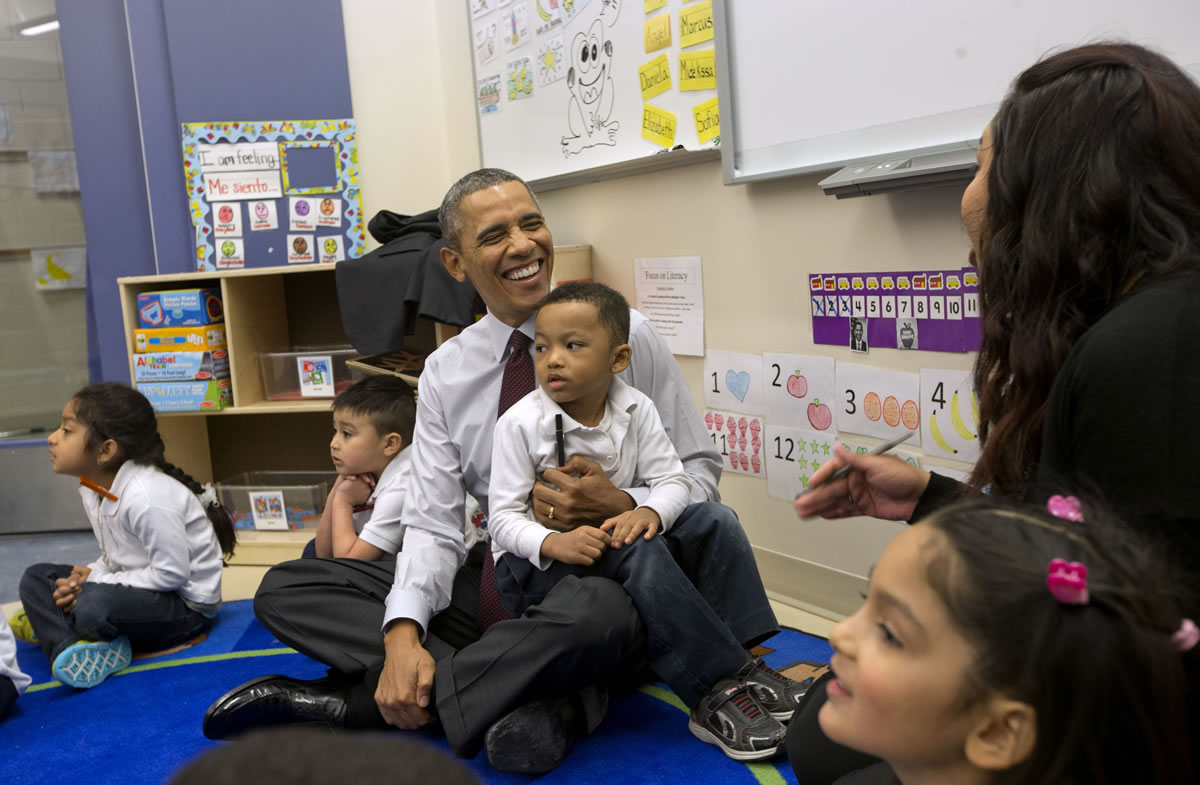 President Barack Obama talks with teacher Graciela Segovia, far right, as he sits with Marcus Wesby and other preschool student during his visit to Powell Elementary School in the Petworth neighborhood of Washington on Tuesday .