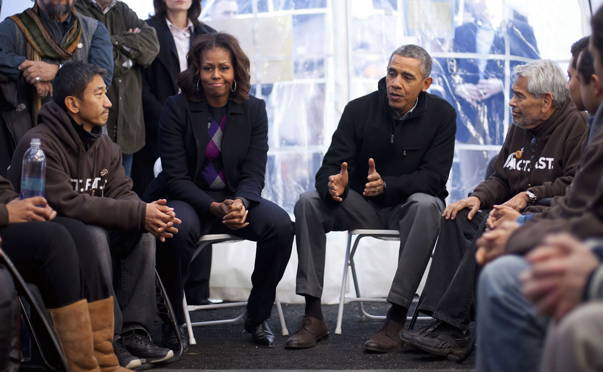 President Barack Obama and first lady Michelle Obama visit with individuals who are taking part in Fast for Families on the National Mall in Washington on Friday.