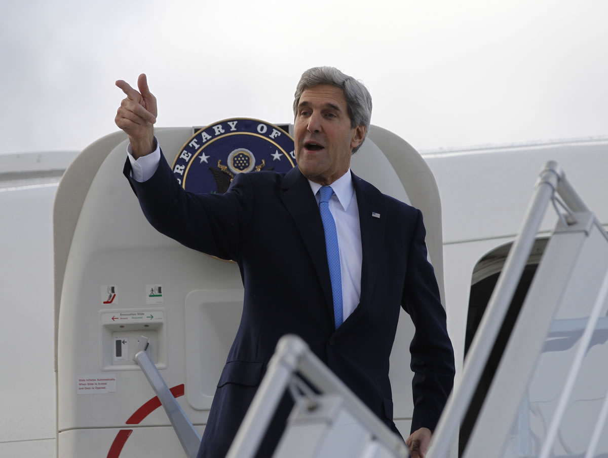 U.S. Secretary of State John Kerry steps aboard his aircraft in Geneva, Switzerland, on Sunday.