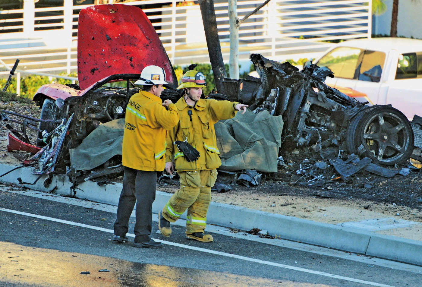 Sheriff's deputies work near the wreckage of a Porsche that crashed into a light pole on Hercules Street near Kelly Johnson Parkway in Valencia, Calif., in this Nov. 30 photo.