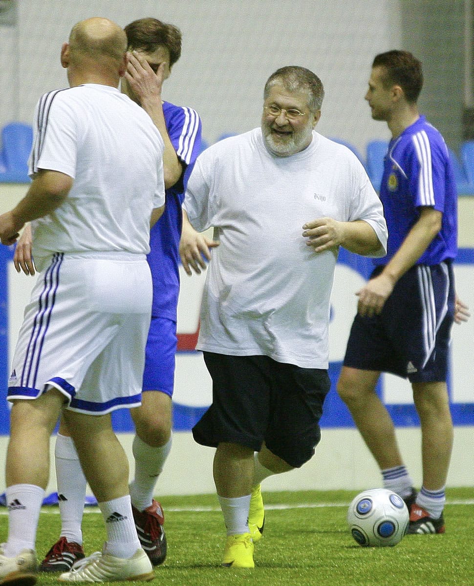 Ukrainian oligarch Igor Kolomoyskiy, center, plays soccer in Kiev, Ukraine.