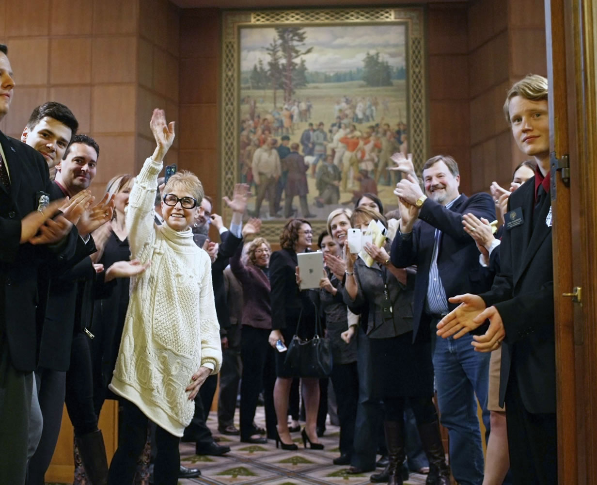 Oregon House members wave across the Capitol to their Senate colleagues at final adjournment Friday in Salem, Ore.