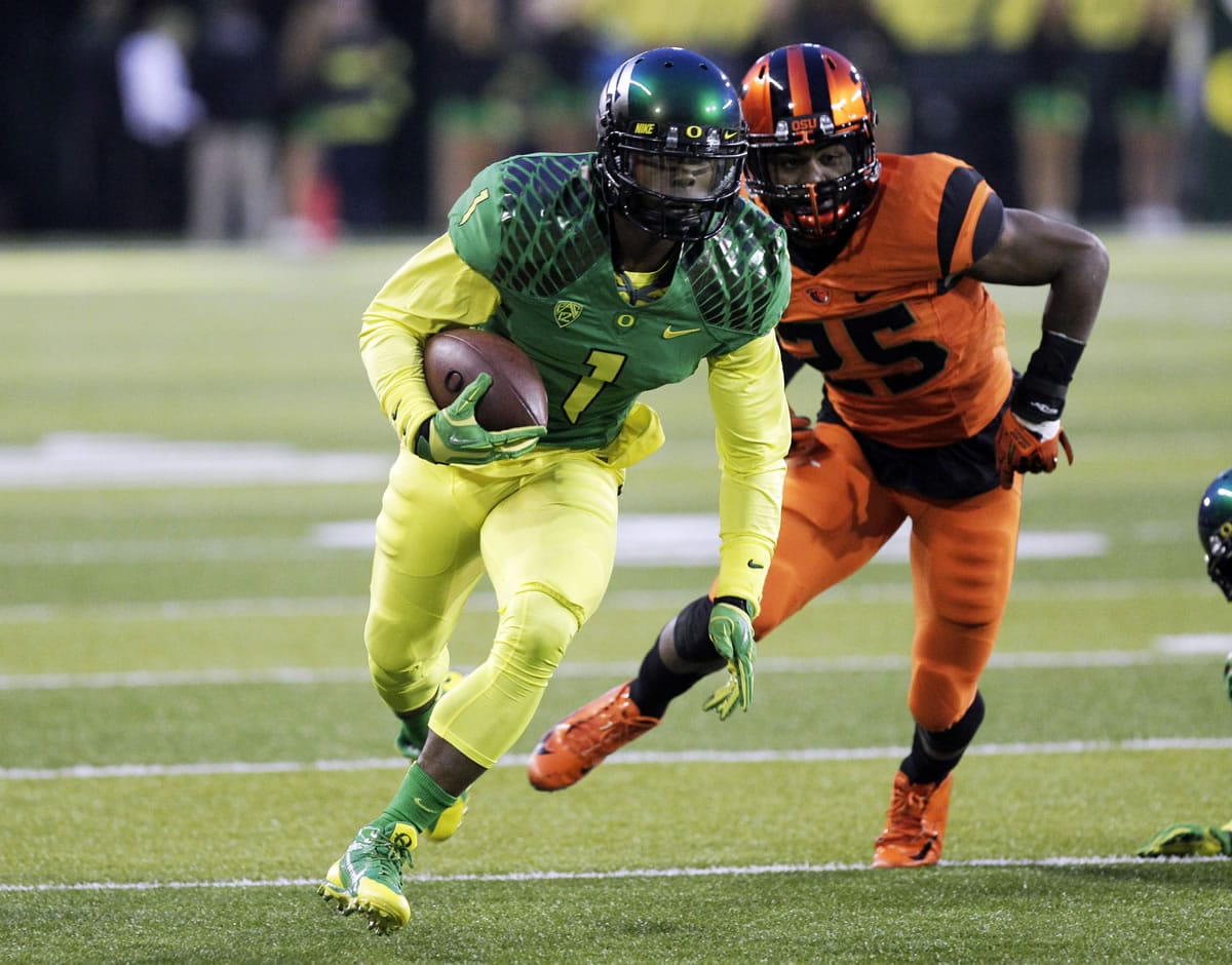 Oregon receiver Josh Huff, left, heads down the field past Oregon State defender Ryan Murphy during the first half Friday.