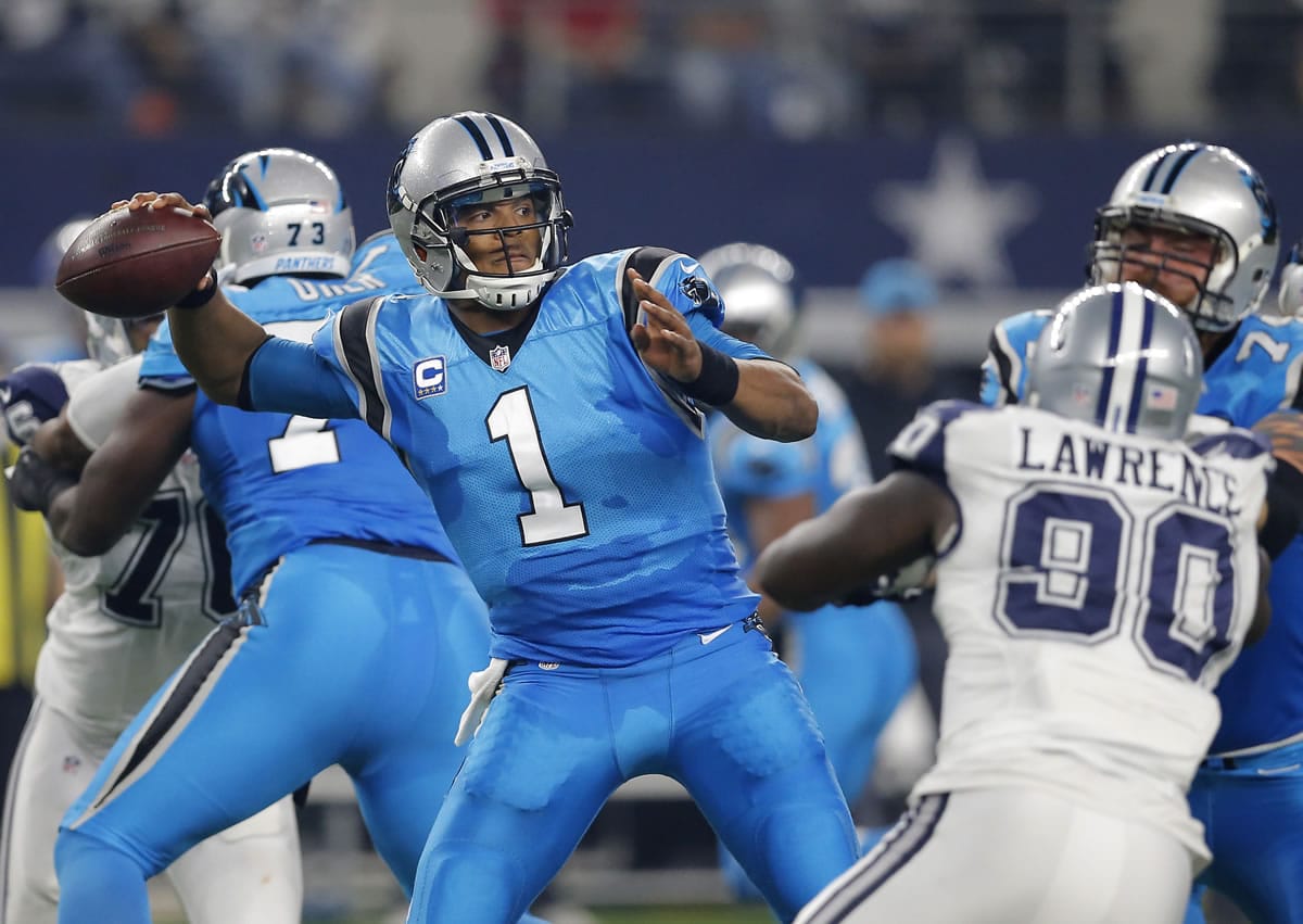 Carolina Panthers quarterback Cam Newton (1) throws a pass under pressure from Dallas Cowboys defensive end Demarcus Lawrence (90) in the first half of an NFL football game, Thursday, Nov. 26, 2015, in Arlington, Texas.