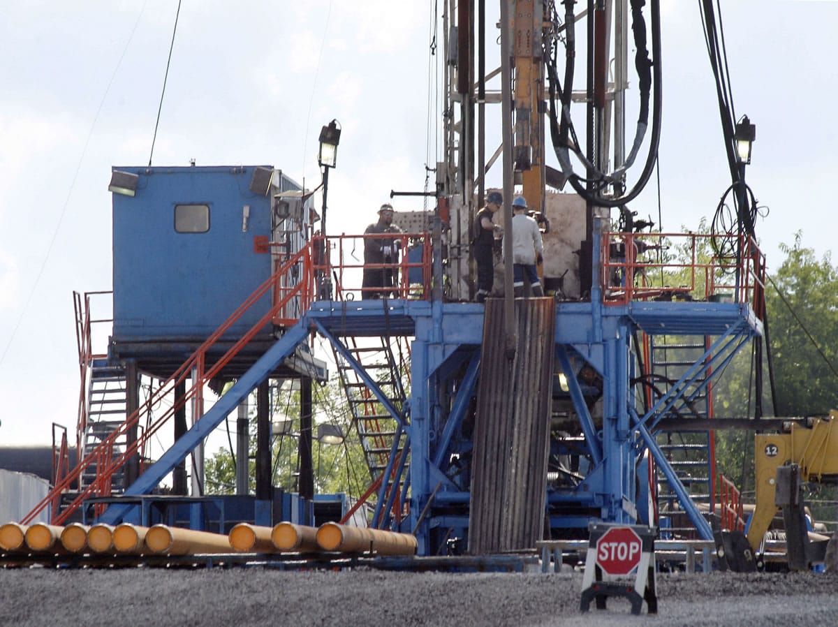 A crew works on a gas drilling rig at a well site for shale based natural gas in Zelienople, Pa.