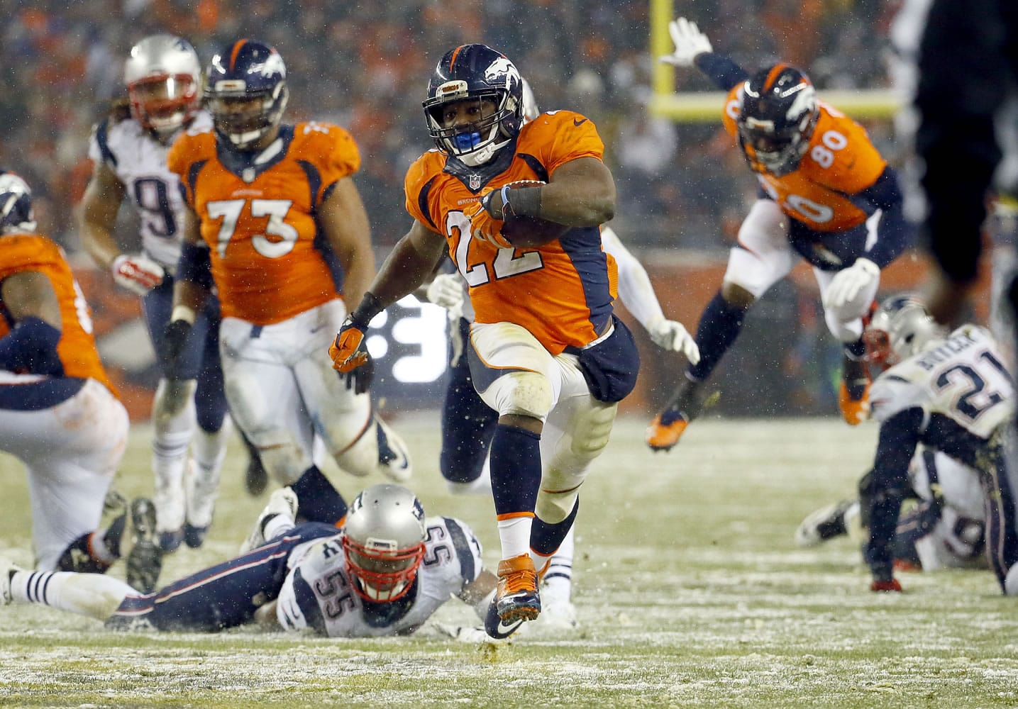 Denver Broncos running back C.J. Anderson (22) breaks free for the game-winning touchdown against the New England Patriots during overtime of an NFL football game, Sunday, Nov. 29, 2015, in Denver. The Broncos defeated the Patriots 30-24.