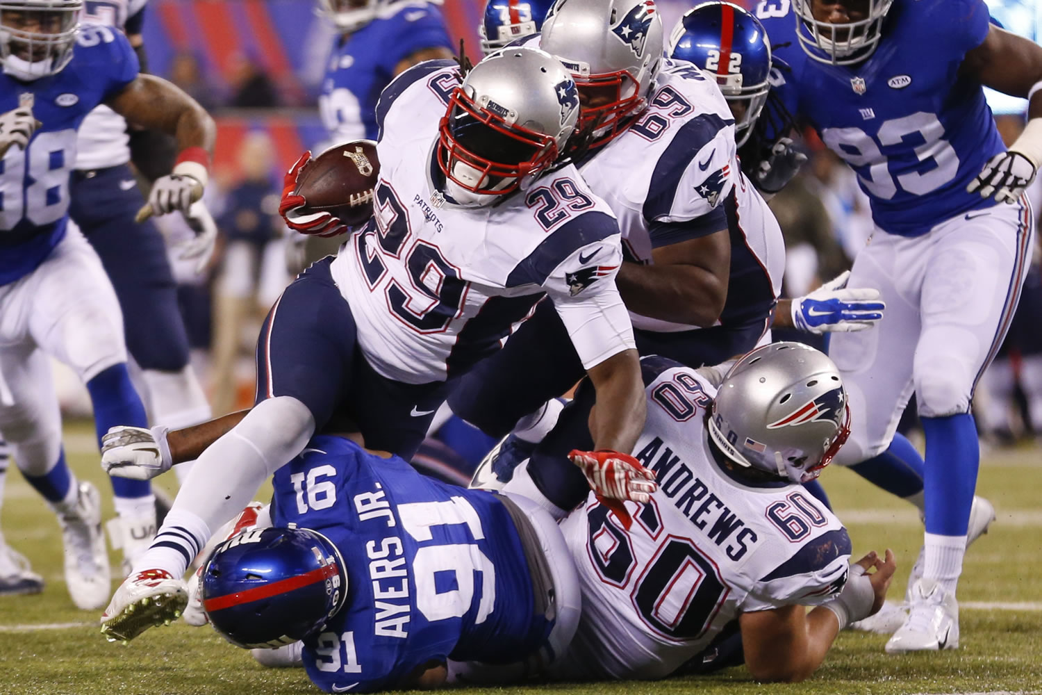 New England Patriots' LeGarrette Blount (29) rushes past New York Giants' Robert Ayers (91) during the second half of an NFL football game Sunday Nov. 15, 2015, in East Rutherford, N.J.