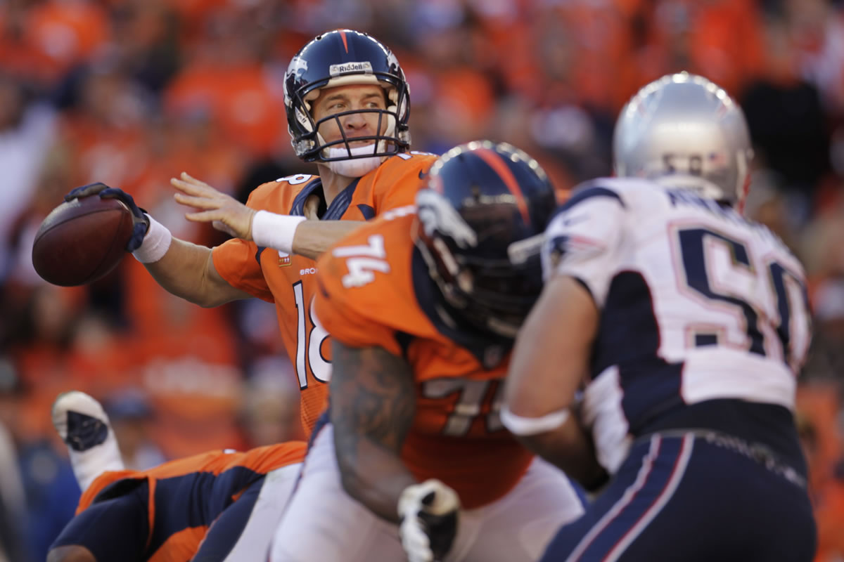 Denver Broncos quarterback Peyton Manning (18) passes during the second half of the AFC Championship game.  Manning threw for 400 yards and two touchdowns Sunday.