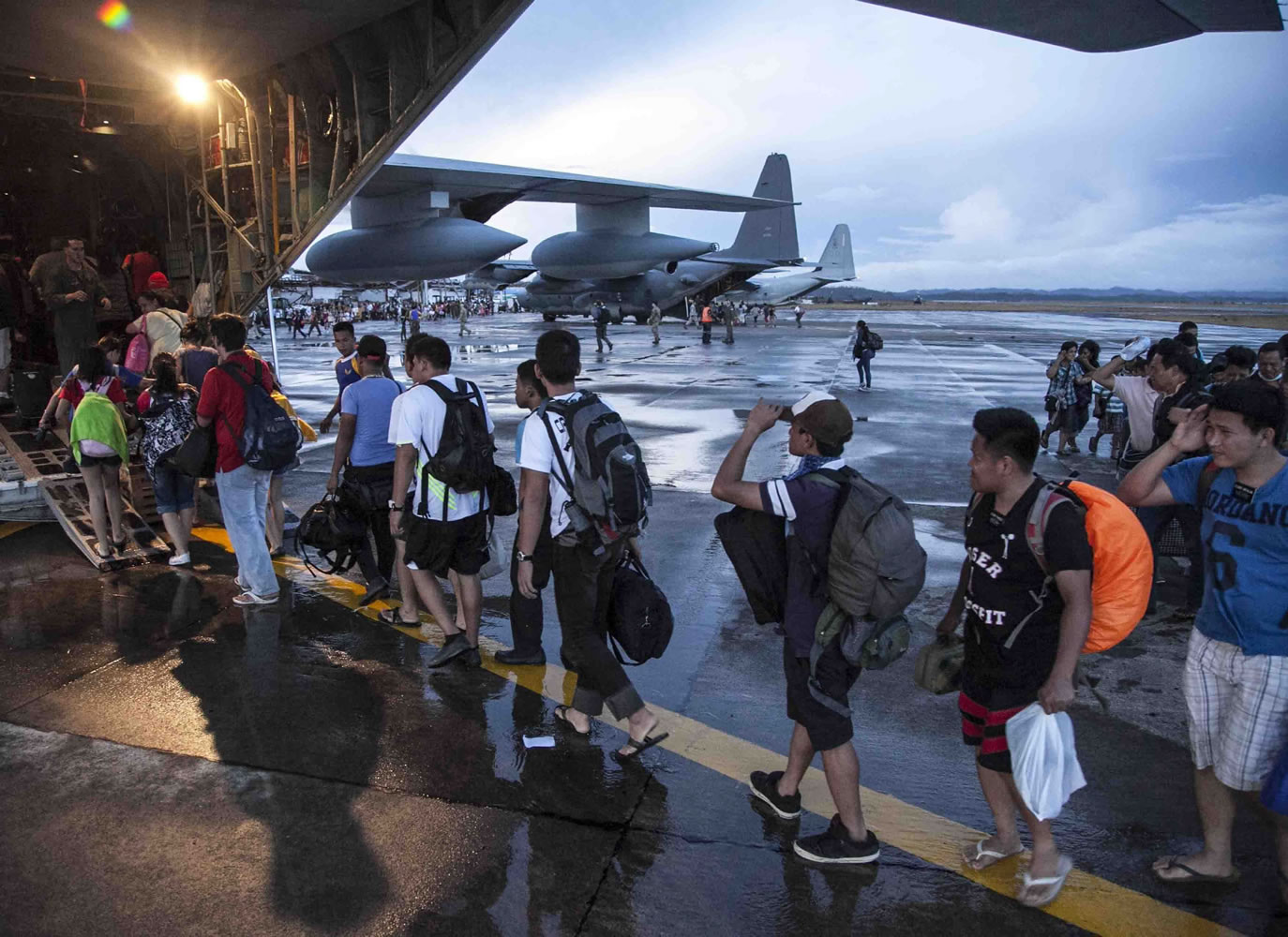 Civilians displaced by Typhoon Haiyan board a U.S.