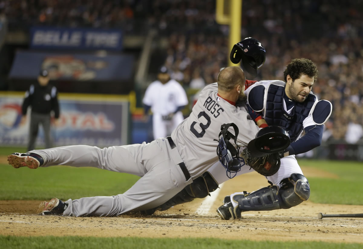 Boston Red Sox's David Ross collides with Detroit Tigers catcher Alex Avila in the second inning during Game 5 of the American League baseball championship series in Detroit.