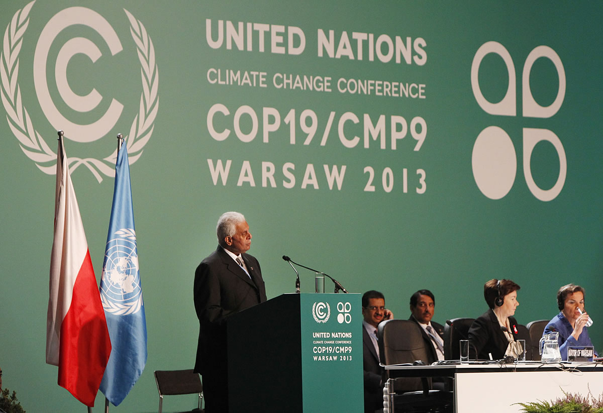 Qatar's Abdullah Bin Hamad Al-Attiyah,left, president of  previous COP18, addresses delegates during the opening session  of the United Nations Climate Change Conference COP19 in Warsaw, Poland, on Monday.