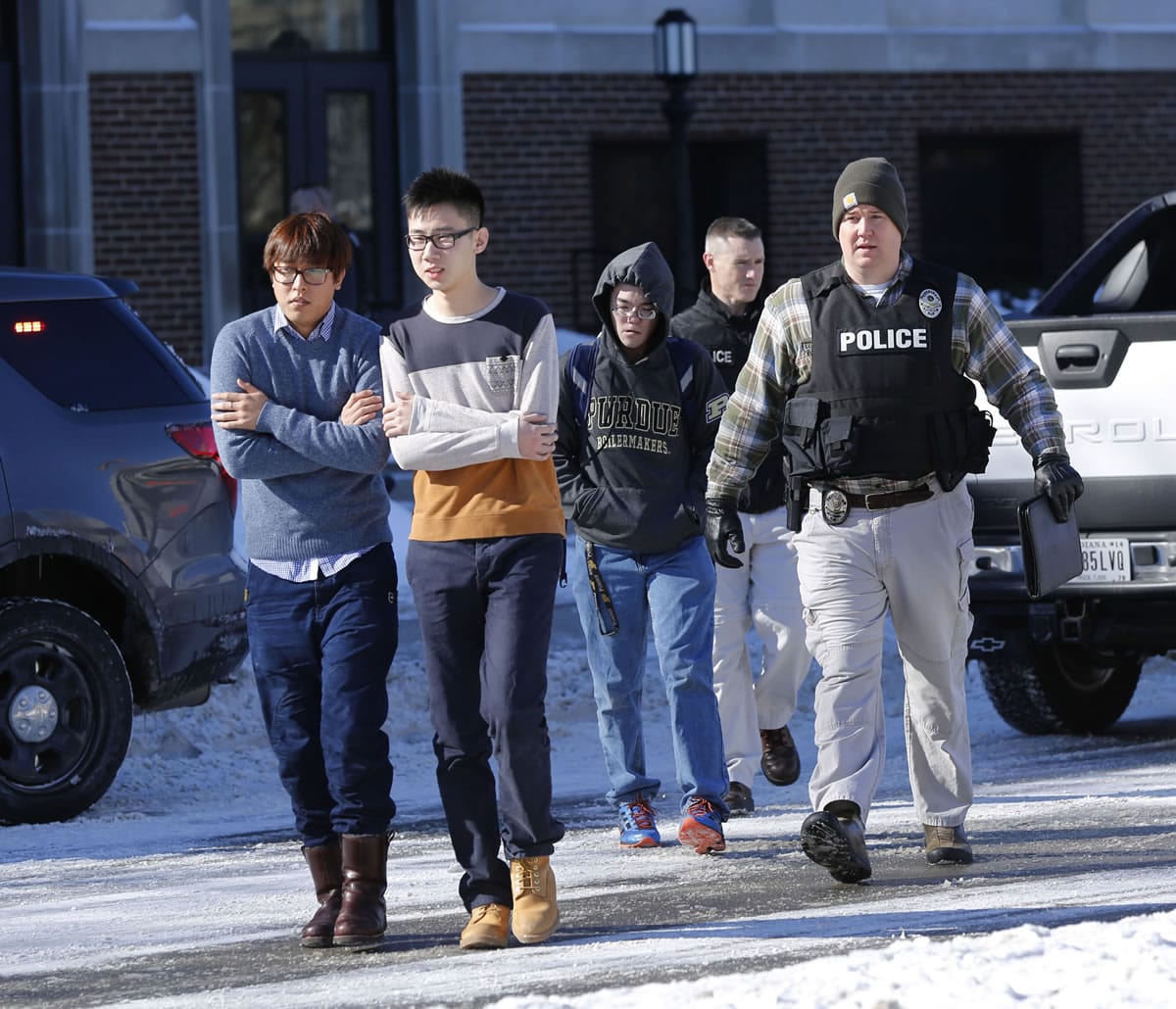 Police evacuate students from the Electrical Engineering building after shots were fired on Tuesday on the campus of Purdue University in West Lafayette, Ind.
