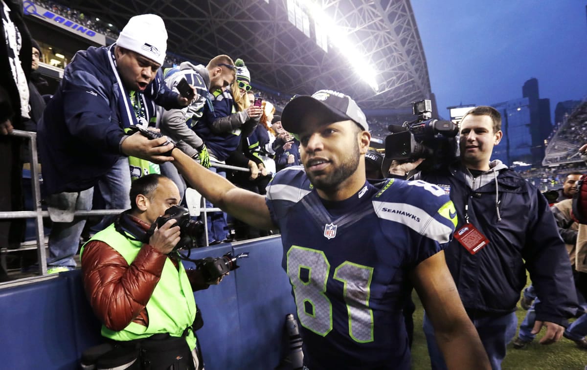 Seattle Seahawks' Golden Tate greets fans as he leaves the field after the team beat the St. Louis Rams in an NFL football game, Sunday, Dec. 29, 2013, in Seattle. The Seahawks won 27-9.