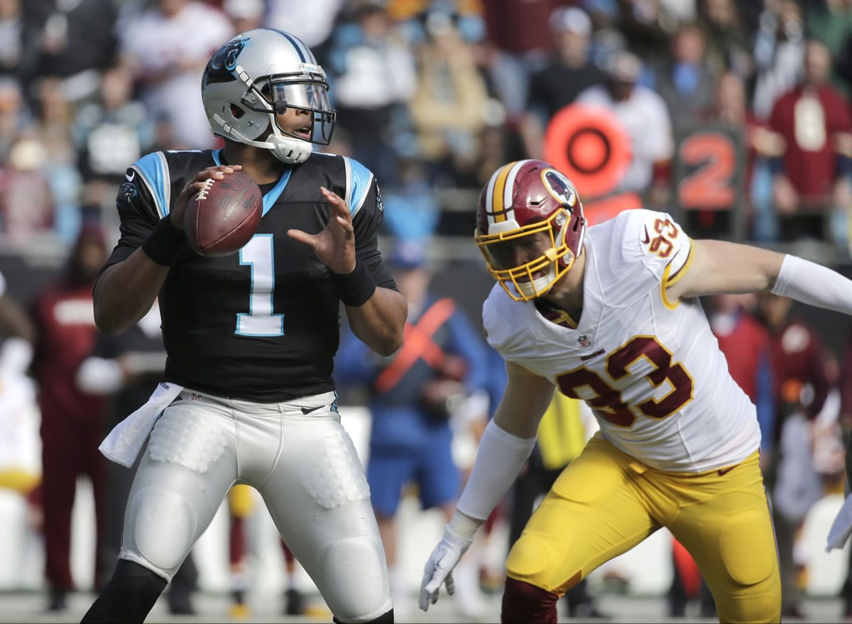 Carolina Panthers' Cam Newton (1) looks to pass as Washington Redskins' Trent Murphy (93) defends in the first half of an NFL football game in Charlotte, N.C., Sunday, Nov. 22, 2015.