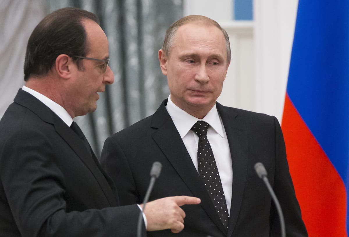 Russian President Vladimir Putin, right, listens as France&#039;s President Francois Hollande speaks to him as they leave their news conference following the talks in Moscow, Russia, Thursday, Nov. 26, 2015.Putin and visiting French President Francois Hollande agreed to share intelligence information and cooperate on selecting targets in the fight against the Islamic State group, raising hope for closer ties between Moscow and the U.S.-led coalition fighting the Islamic State group following the Paris attacks.