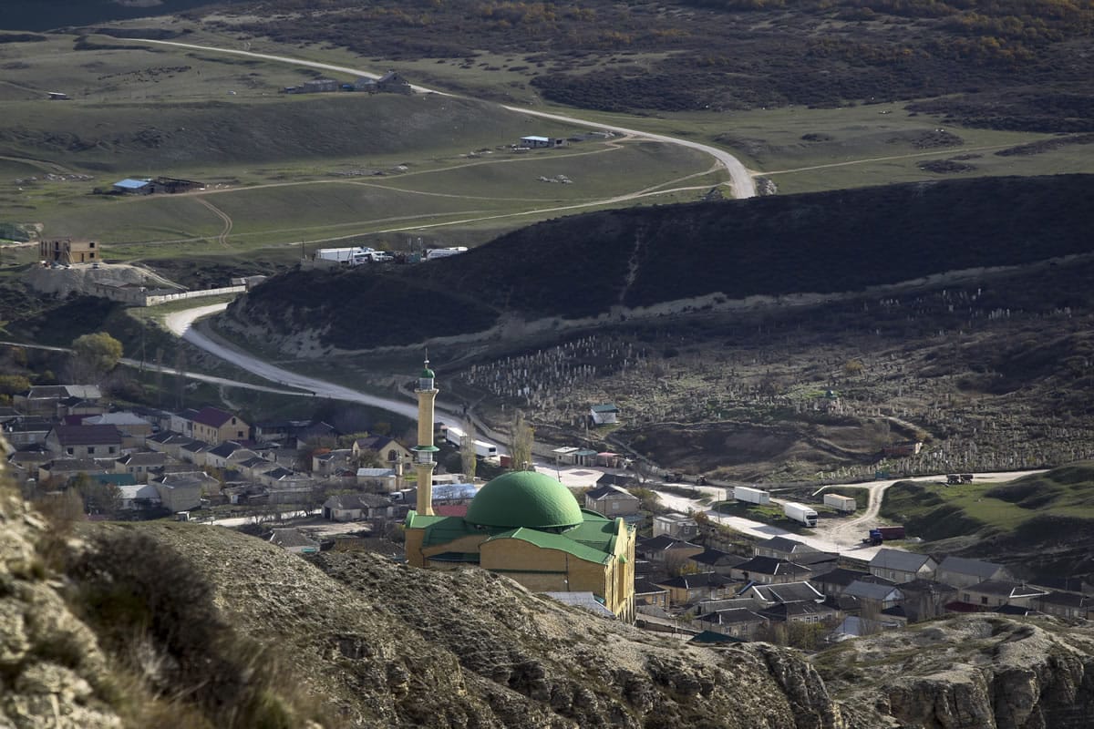 In this photo taken on Thursday, Nov.  12, 2015, a mosque is seen from the mountains in the village of Gubden, Dagestan, Russia. An epidemic of recruitment for the Islamic State group has swept through the predominantly Muslim Dagestan where young men and women are leaving for Syria, pursuing a religious ideal or trying to escape police profiling.