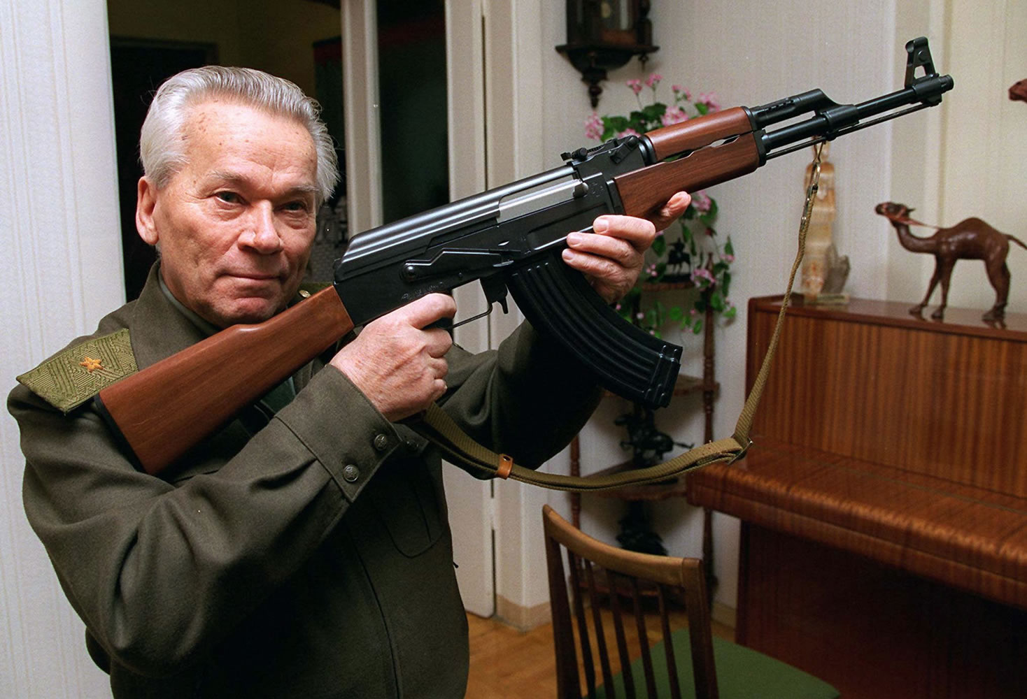 Mikhail Kalashnikov shows a model of his world-famous AK-47 assault rifle at home in the Ural Mountain city of Izhevsk, 625 miles east of Moscow in 1997.