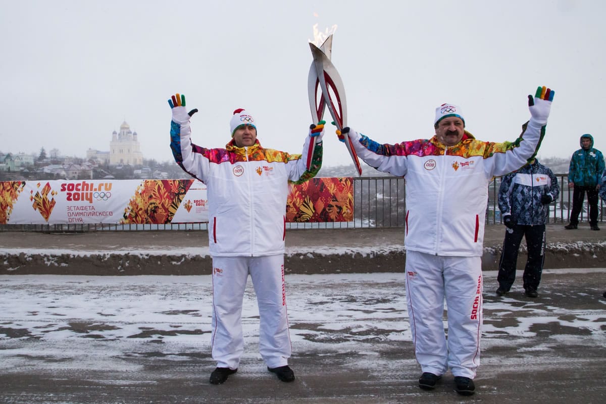Torch bearers hold Olympic torches Jan.
