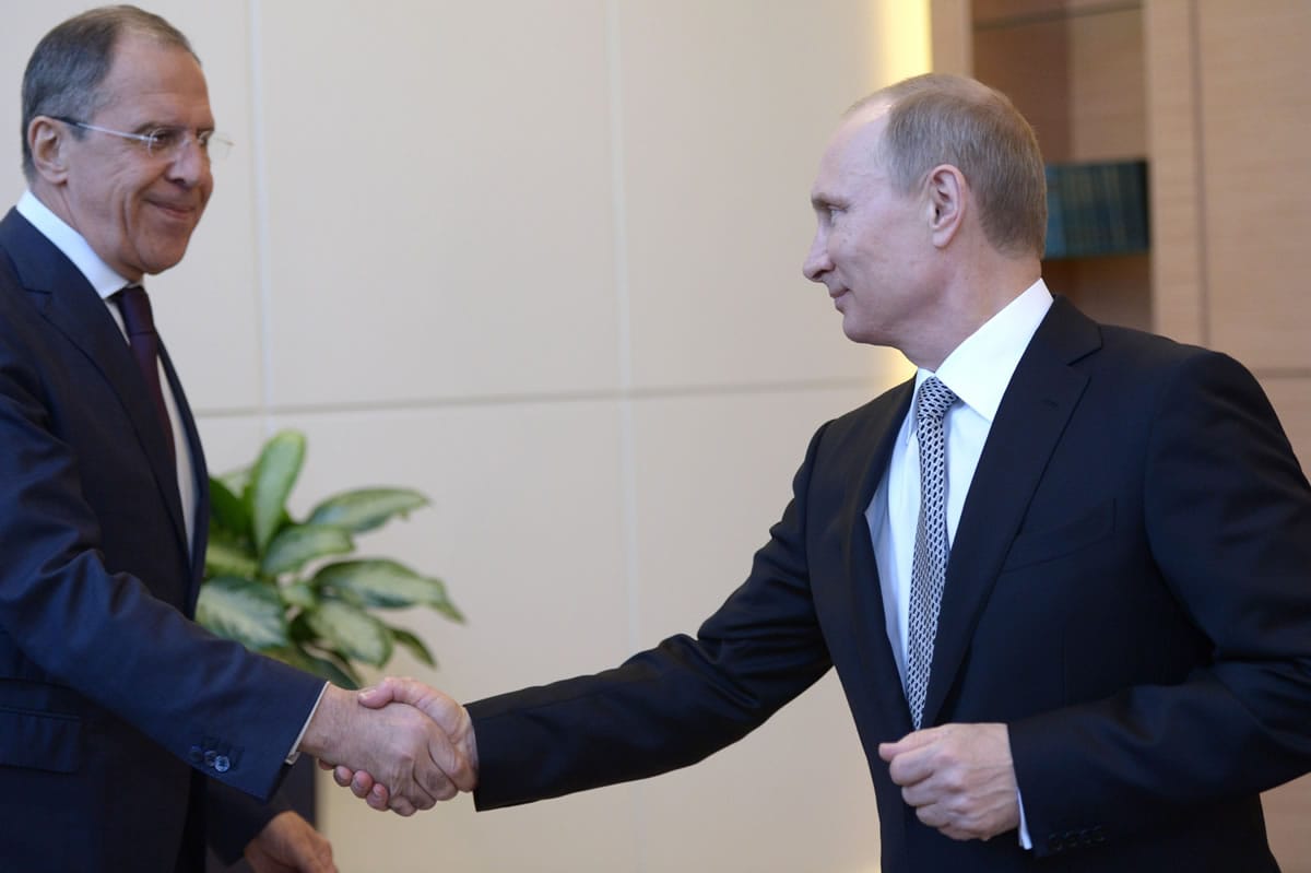 Russian President Vladimir Putin, right, shakes hands with Foreign Minister Sergey Lavrov, during a meeting at the Bocharov Ruchei residence in Sochi, southern Russia, Monday, March 10, 2014.