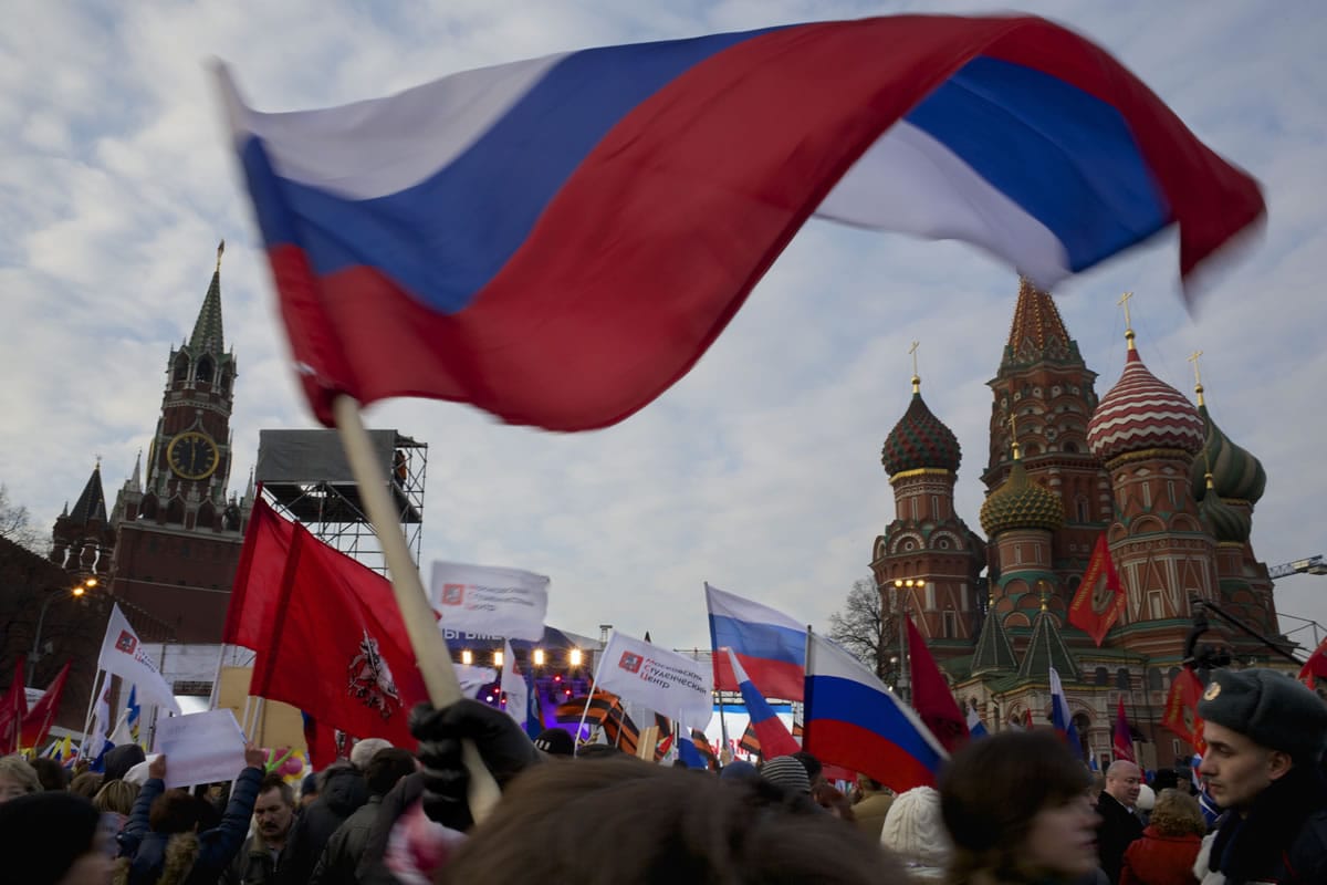 Pro-Putin demonstrators wave Russian national flags as they head toward to Red Square on Friday in Moscow. Spassky Tower is at left, and St.