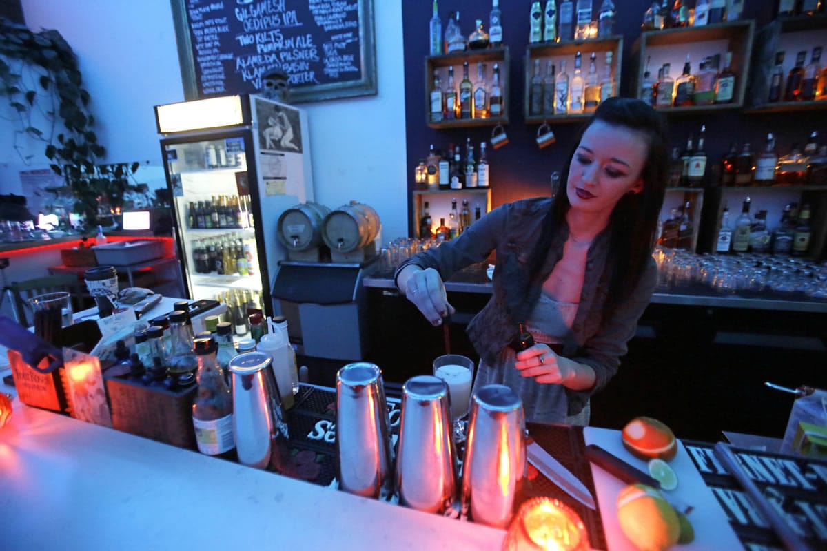 Lightbar worker Kathy Brandt pours a drink Thursday. The bar features light boxes designed to help those with seasonal affective disorder, which affects an estimated 3 percent to 5 percent of Americans.