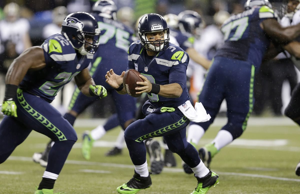 Seattle Seahawks quarterback Russell Wilson drops back against the New Orleans Saints, Monday, Dec.