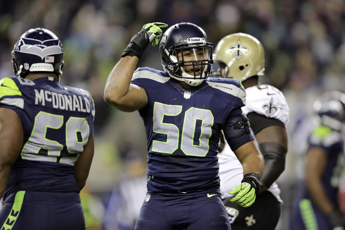 Seattle Seahawks K.J. Wright (50) gestures after a play against the New Orleans Saints in the second half of an NFL football game, Monday, Dec. 2, 2013, in Seattle.
