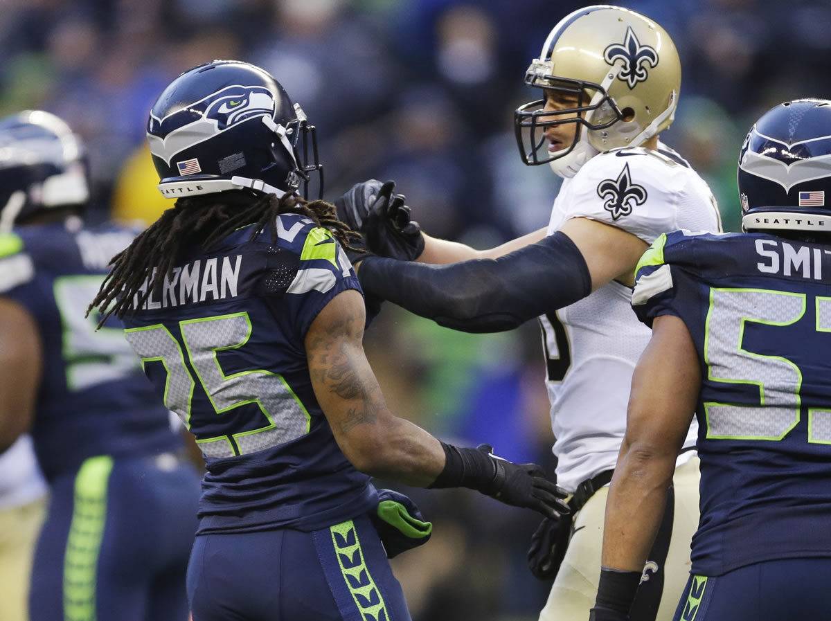 New Orleans tight end Jimmy Graham gets in a scuffle with Seattle's Richard Sherman (25) during a playoff game in 2014.