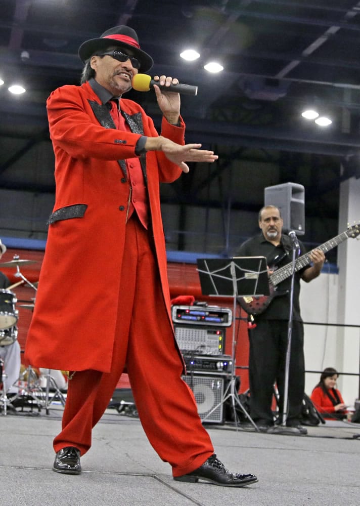 Pancho Claus, portrayed by Richard Reyes, sings &quot;Feliz Navidad&quot; at a holiday event in Houston.