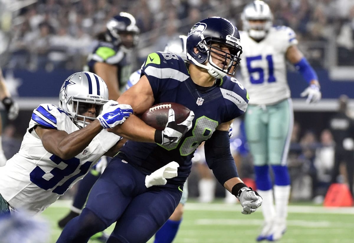 Dallas Cowboys' Byron Jones (31) tackles Seattle Seahawks' Jimmy Graham (88) after Graham caught a pass in the second half of an NFL football game Sunday, Nov. 1, 2015, in Arlington, Texas.