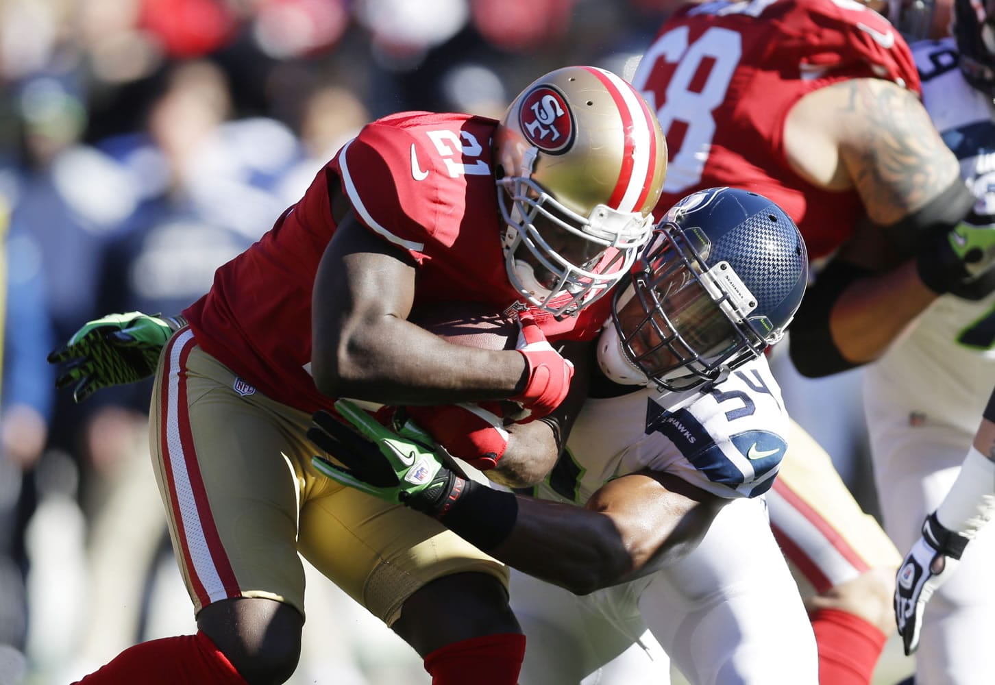 San Francisco 49ers running back Frank Gore (21) is tackled by Seattle Seahawks' middle linebacker Bobby Wagner (54) in the first half Sunday.