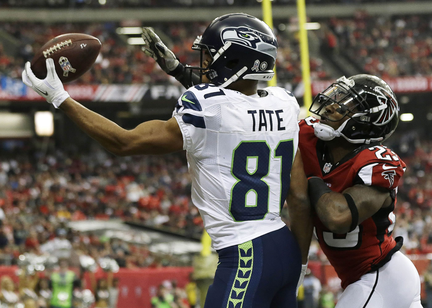 Seattle Seahawks wide receiver Golden Tate (81) makes a touchdown catch against Atlanta Falcons cornerback Robert Alford (23) in the closing seconds of the second quarter Sunday. Replay review confirmed the touchdown.