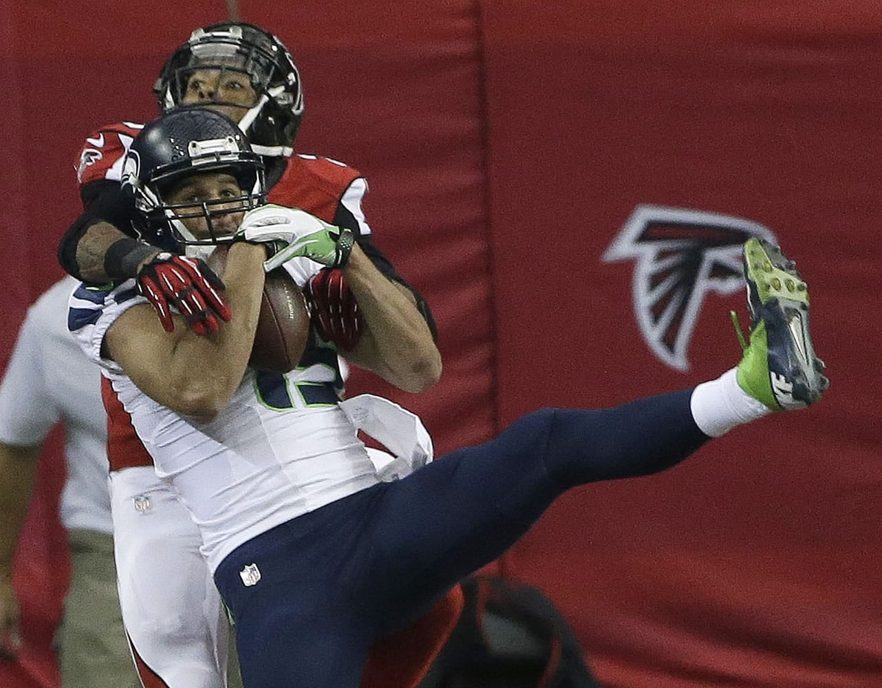 Seattle Seahawks wide receiver Jermaine Kearse (15) makes a touchdown catch against Atlanta Falcons free safety Thomas DeCoud (28) during the second quarter Sunday in Atlanta.