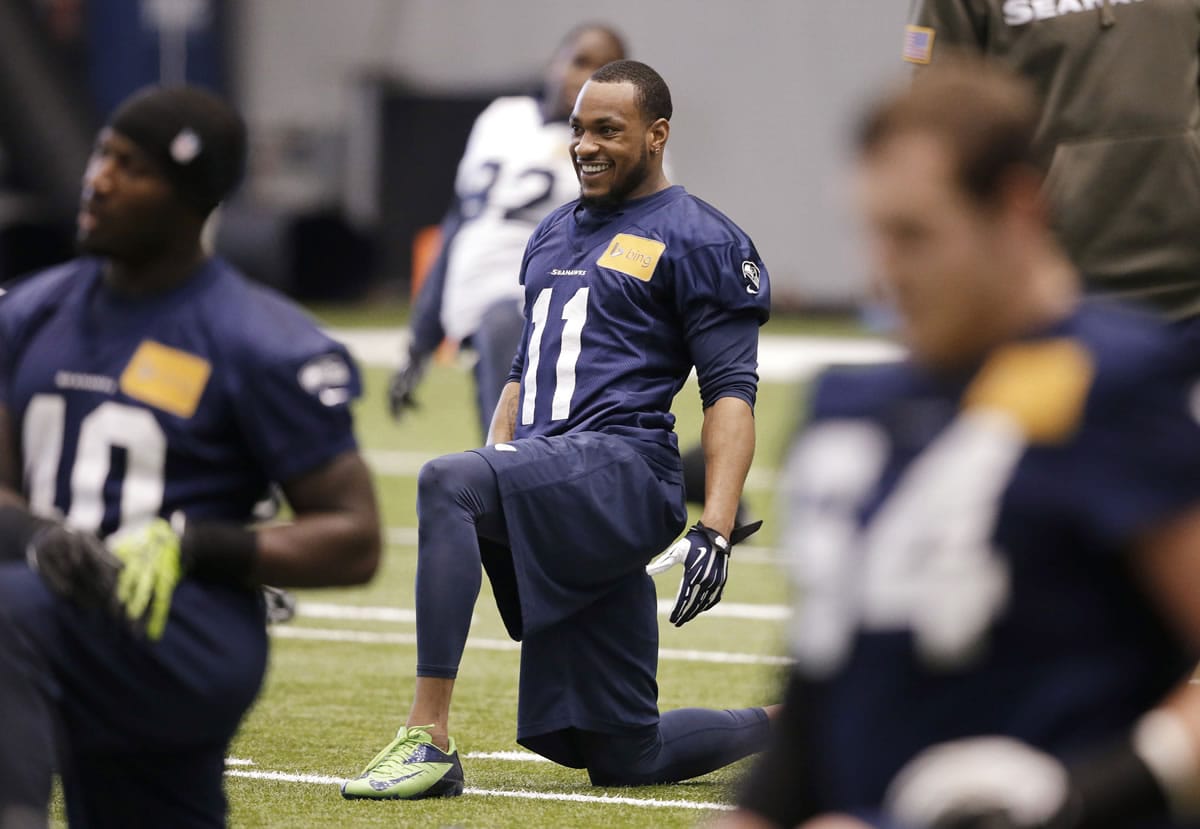 Seattle Seahawks' Percy Harvin (11) smiles as he stretches during practice last week.
