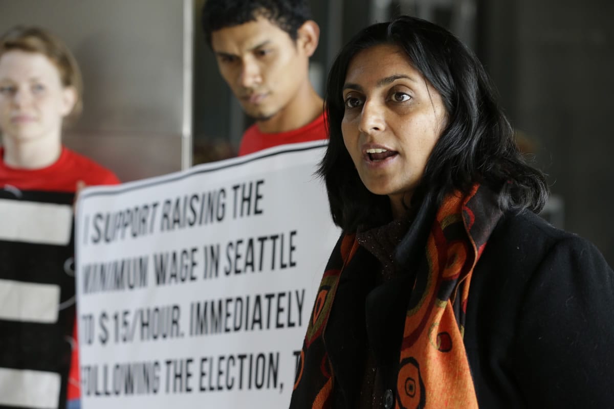 Kshama Sawant, right, then a candidate for Seattle City Council, speaks Nov. 4 outside City Council chambers in Seattle about her support for raising the minimum wage to $15 an hour for all workers in the city.