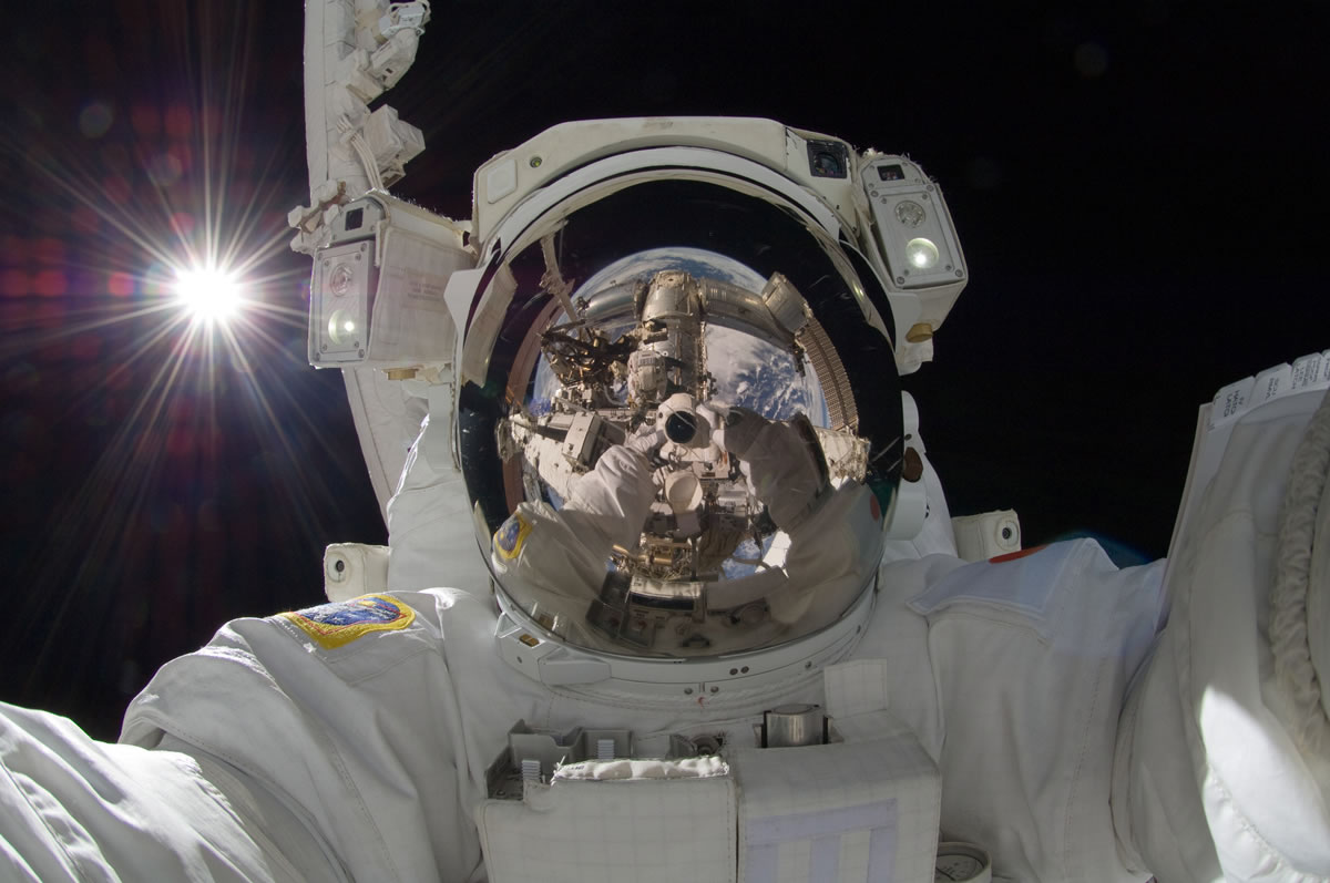 Japan Aerospace Exploration Agency astronaut Aki Hoshide, Expedition 32 flight engineer, uses a digital still camera to take a photo of his helmet visor during a spacewalk