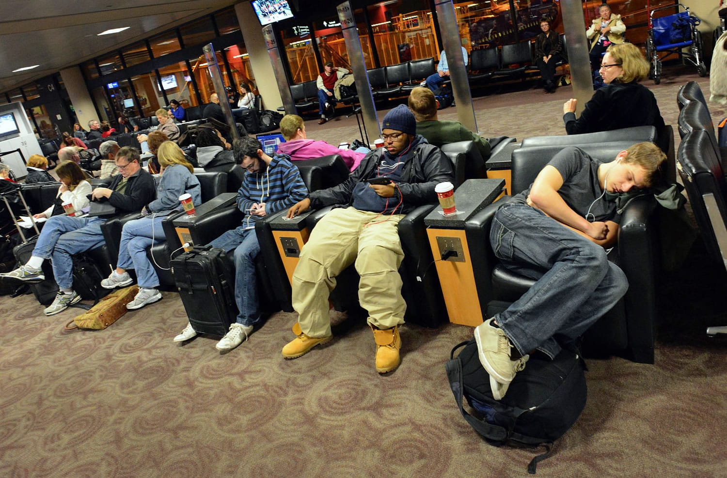 Travelers wait for a flight at a terminal gate at Phoenix Sky Harbor Airport in Phoenix on Tuesday morning.