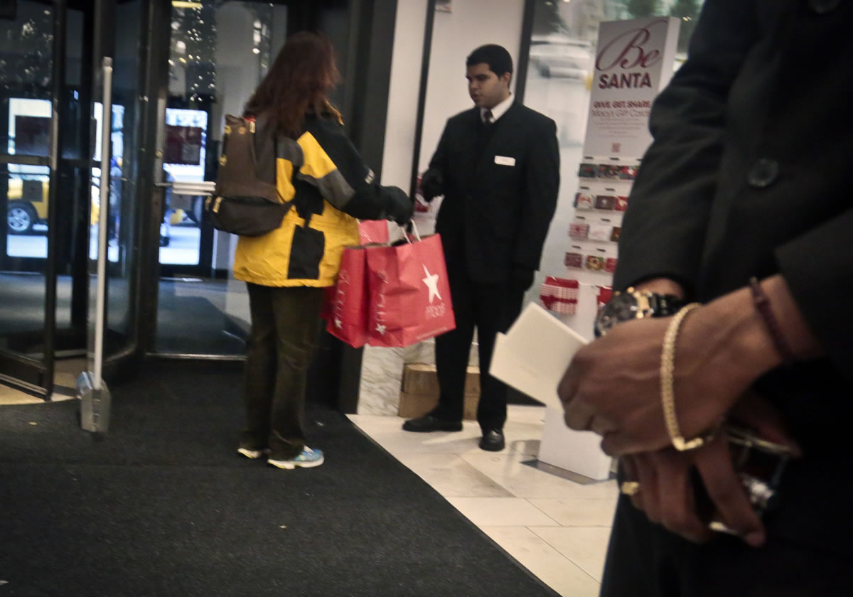 A security agent checks the bags of a shopper at Macy's in New York.