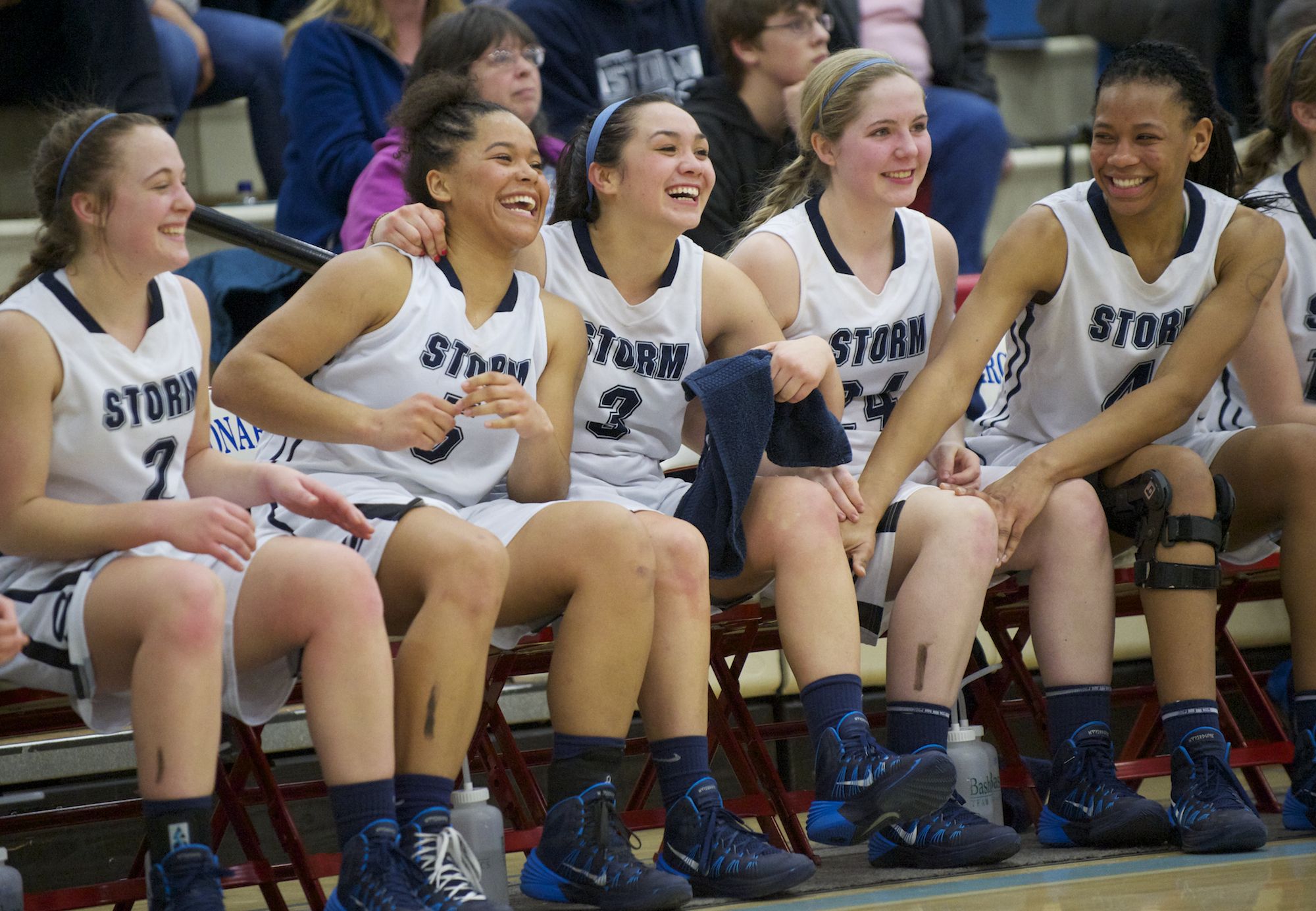 Skyview's Hannahjoy Adams, Aubrey Ward-El, Stephanie McDonagh, Kirsten Johnson and Jocelyn Adams, from left, take in the Storm's victory over Newport in a Class 4A regional game Saturday at Longview.