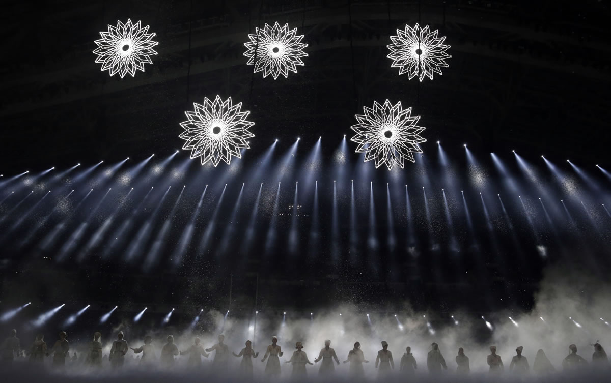 Artists perform as snow flakes start forming the Olympic rings during the opening ceremony of the 2014 Winter Olympics in Sochi, Russia today.
